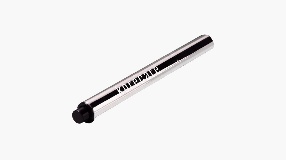 KoreCare Extreme Lip Plumper click pen on a light grey background