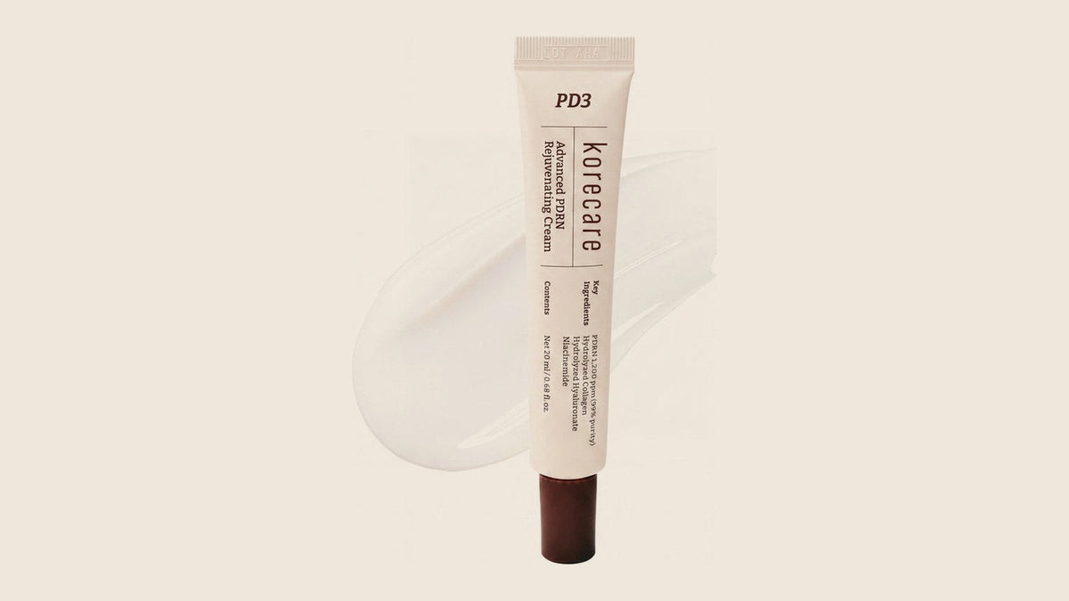 KoreCare PDRN cream tube with a swatch of white gel cream on a warm beige background